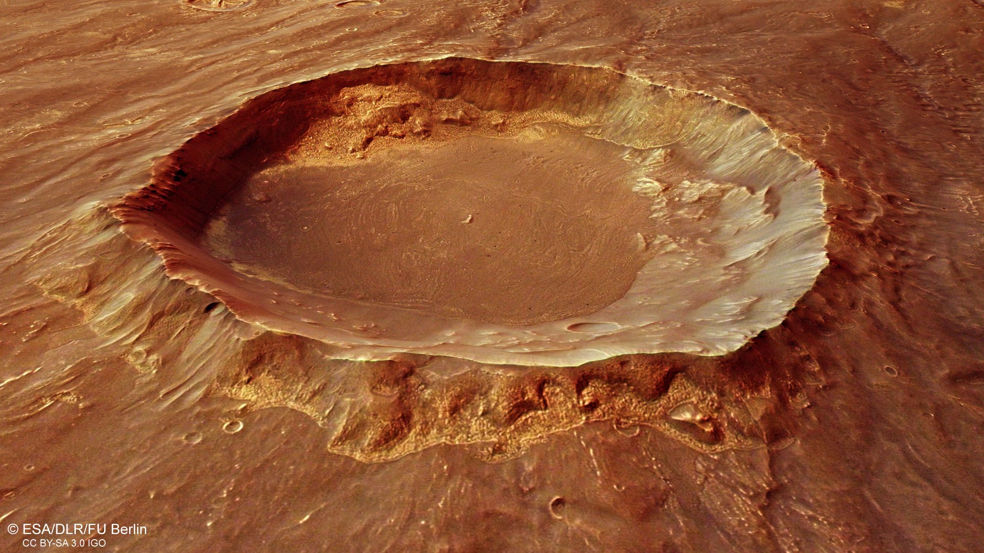 Blick in einen Krater mit hellen Ablagerungen in der Region Thaumasia
