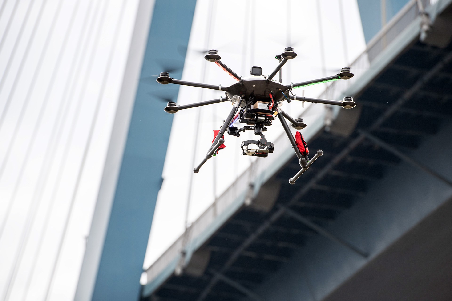 Fliegende Drohne vor einer Brücke
