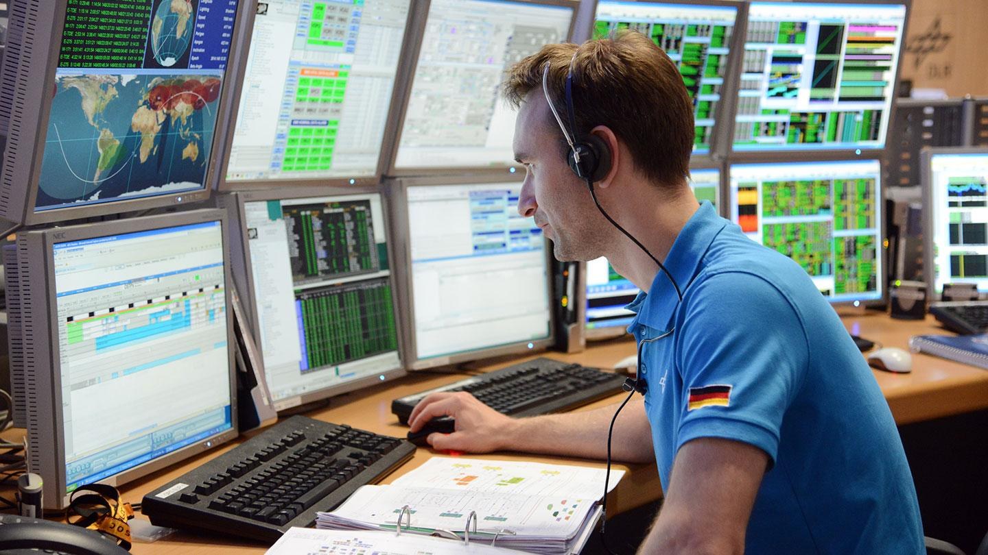 Foto DLR-Mitarbeiter vor Bildschirmen der Position STRATOS im Columbus-Kontrollzentrum in Oberpfaffenhofen