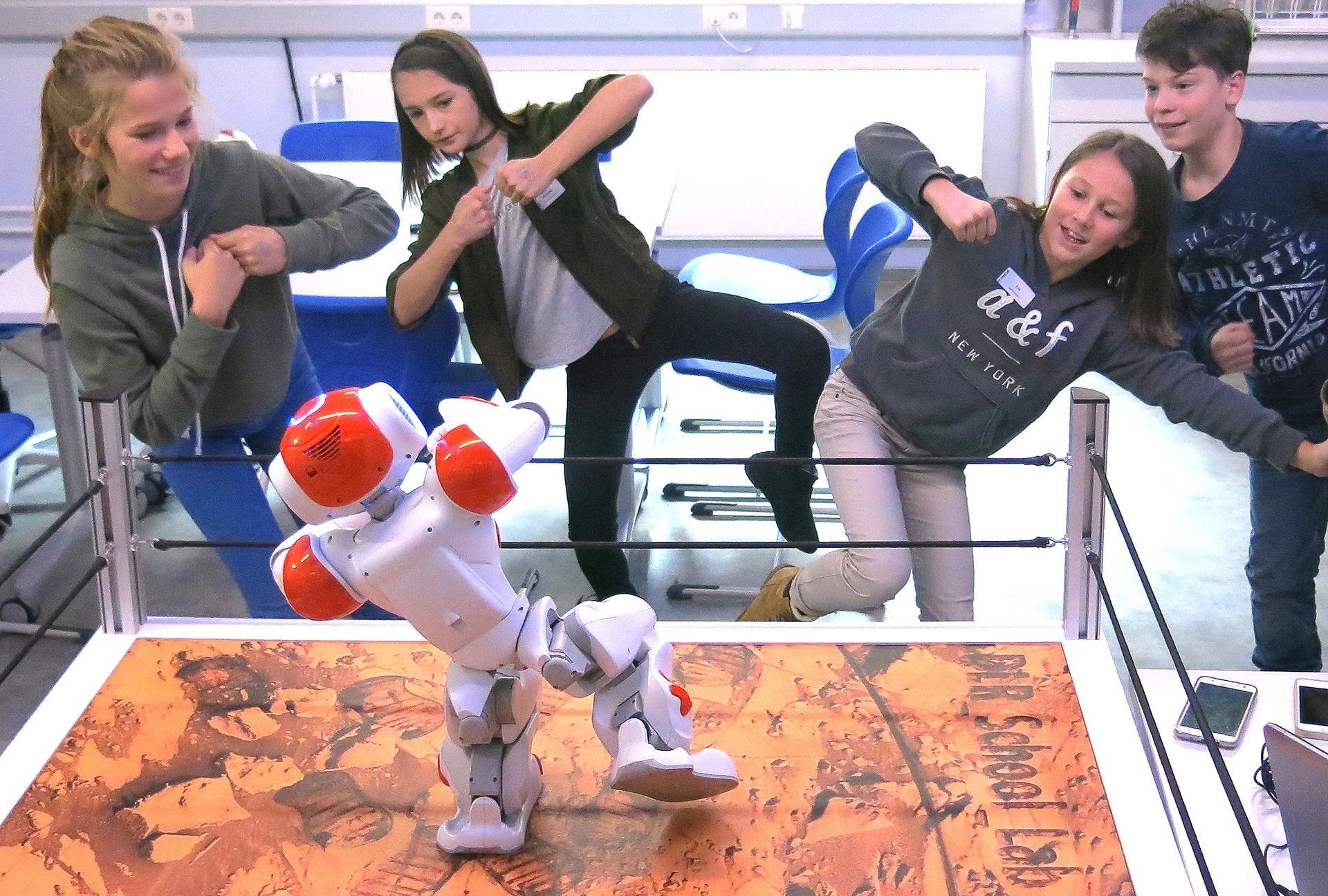 Grundprinzipien der aktuellen Forschung verstehen – das geht am besten auf spielerische Art. Hier tanzen Jugendliche mit einem Roboter, den sie vorher selbst programmiert haben.