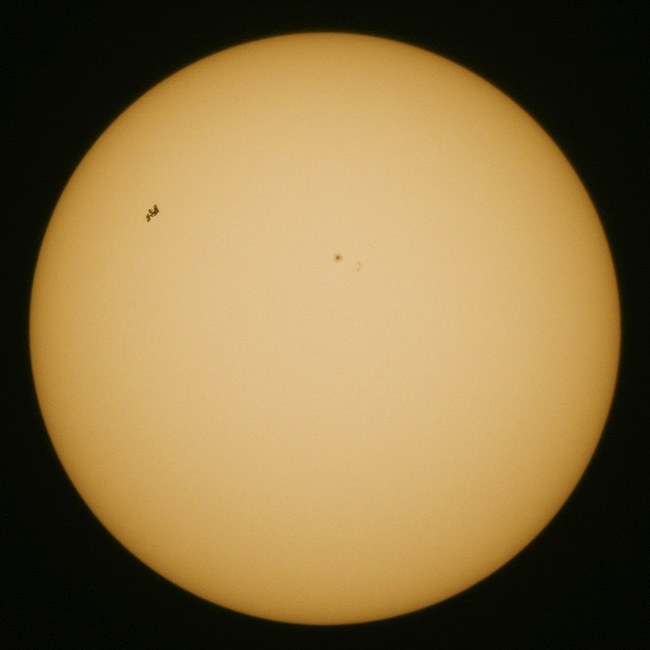 ISS and Shuttle transit the sun on 23/05/2010. Image: DLR.