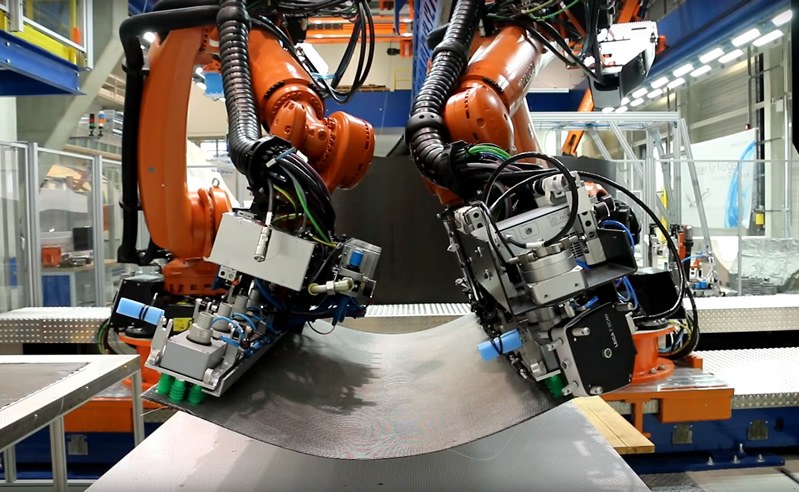 Two collaborating robots carrying a CFRP cutpiece