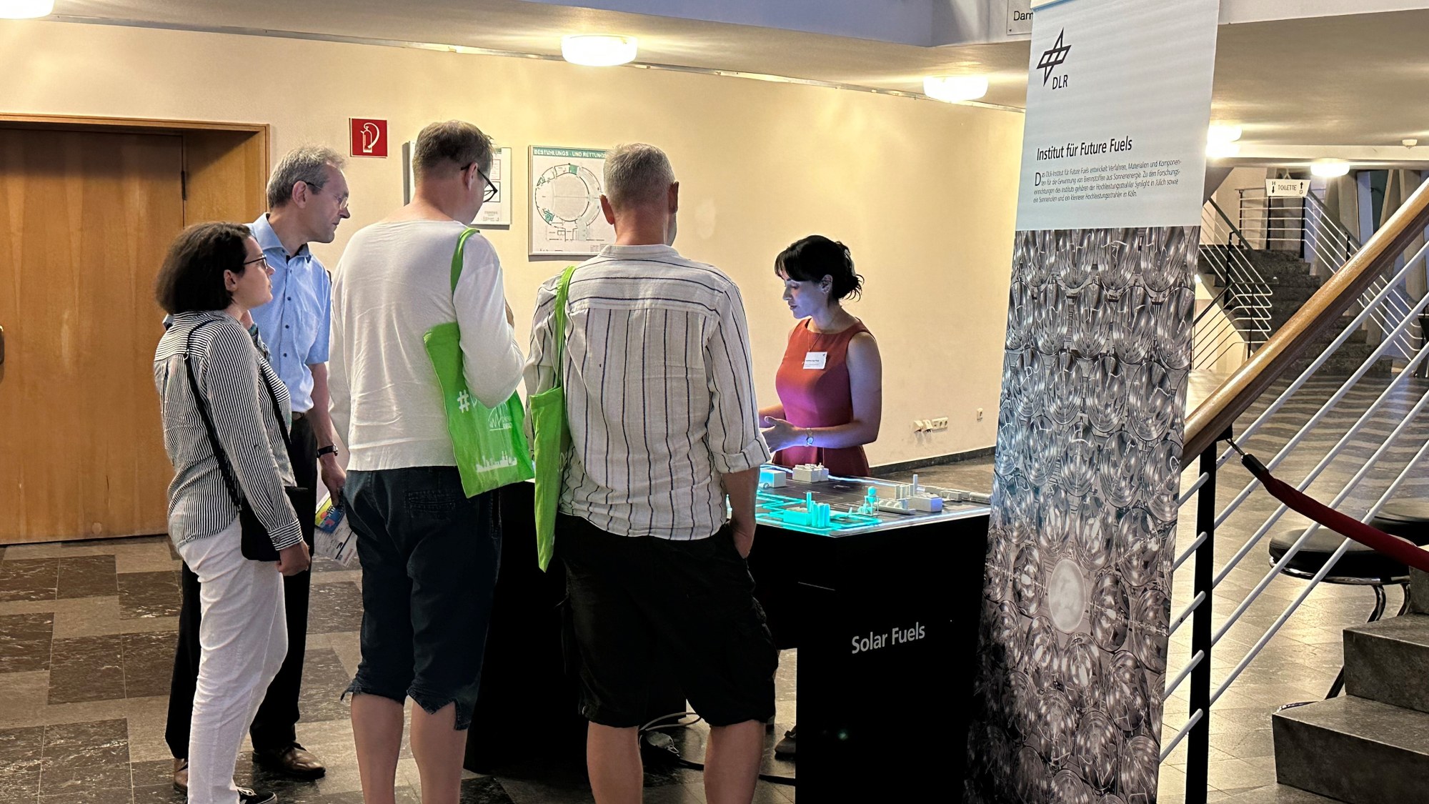 Visitors stand at the DLR stand at the Night of Technology 2023.