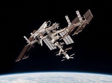 The International Space Station with the space shuttle (upper left) and ATV-2 (lower right)