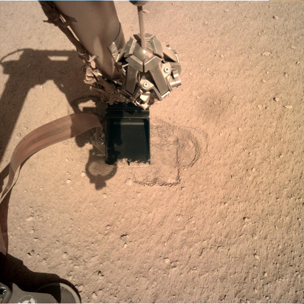 The robotic arm of the InSight lander at the Mole hole