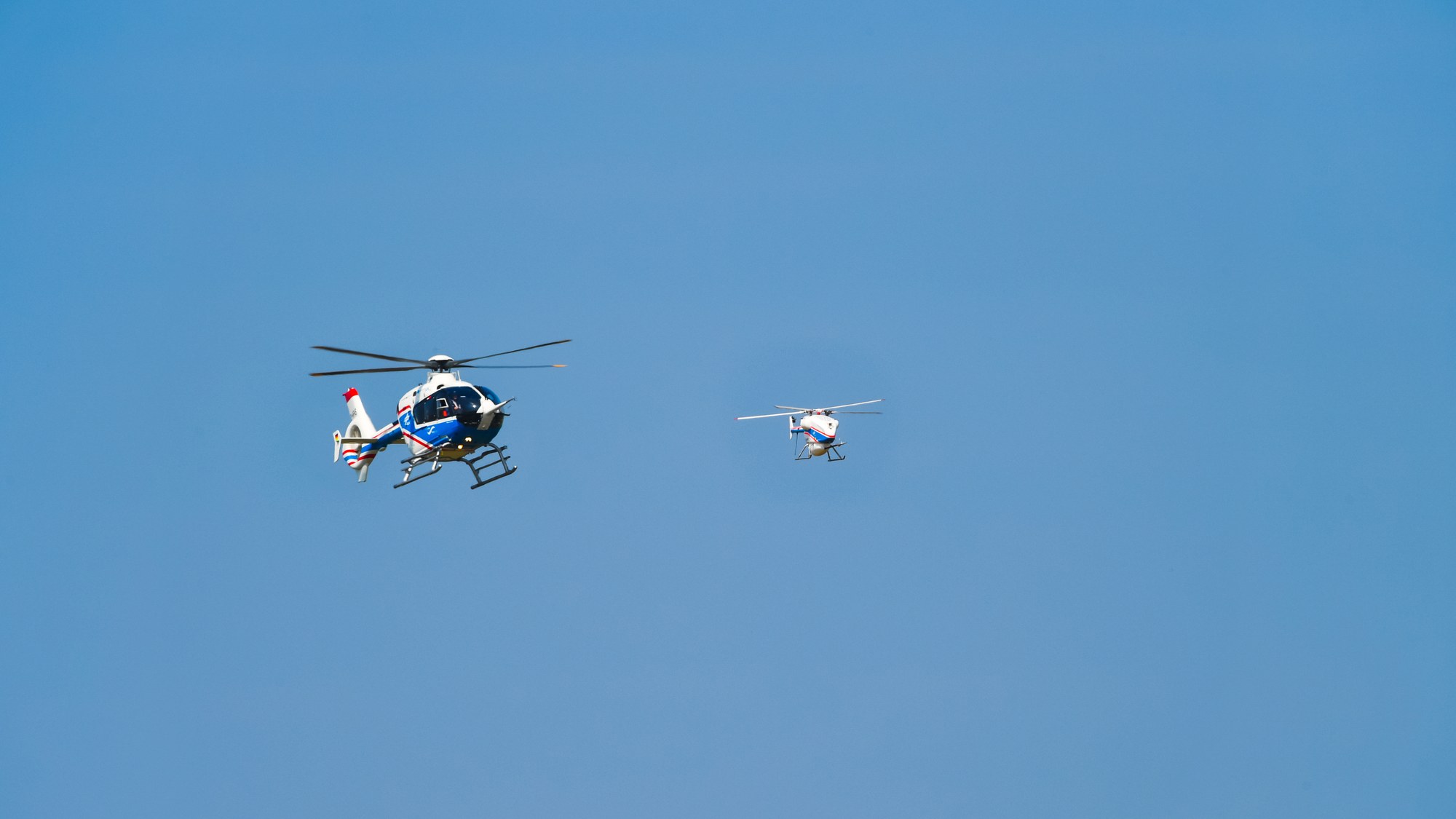 Trialling cooperative behaviour by unmanned helicopters during flight tests