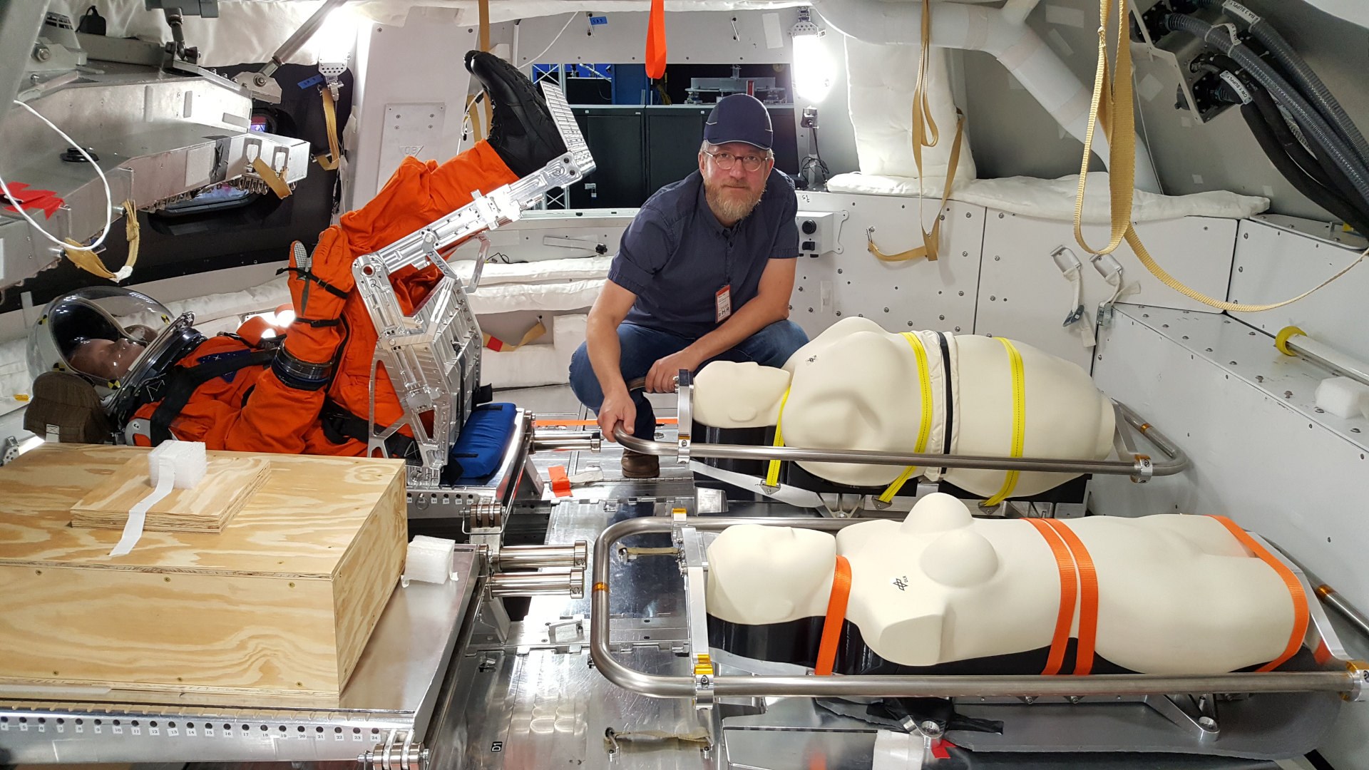 DLR radiation biologist Dr Thomas Berger with the dummies in the Orion capsule