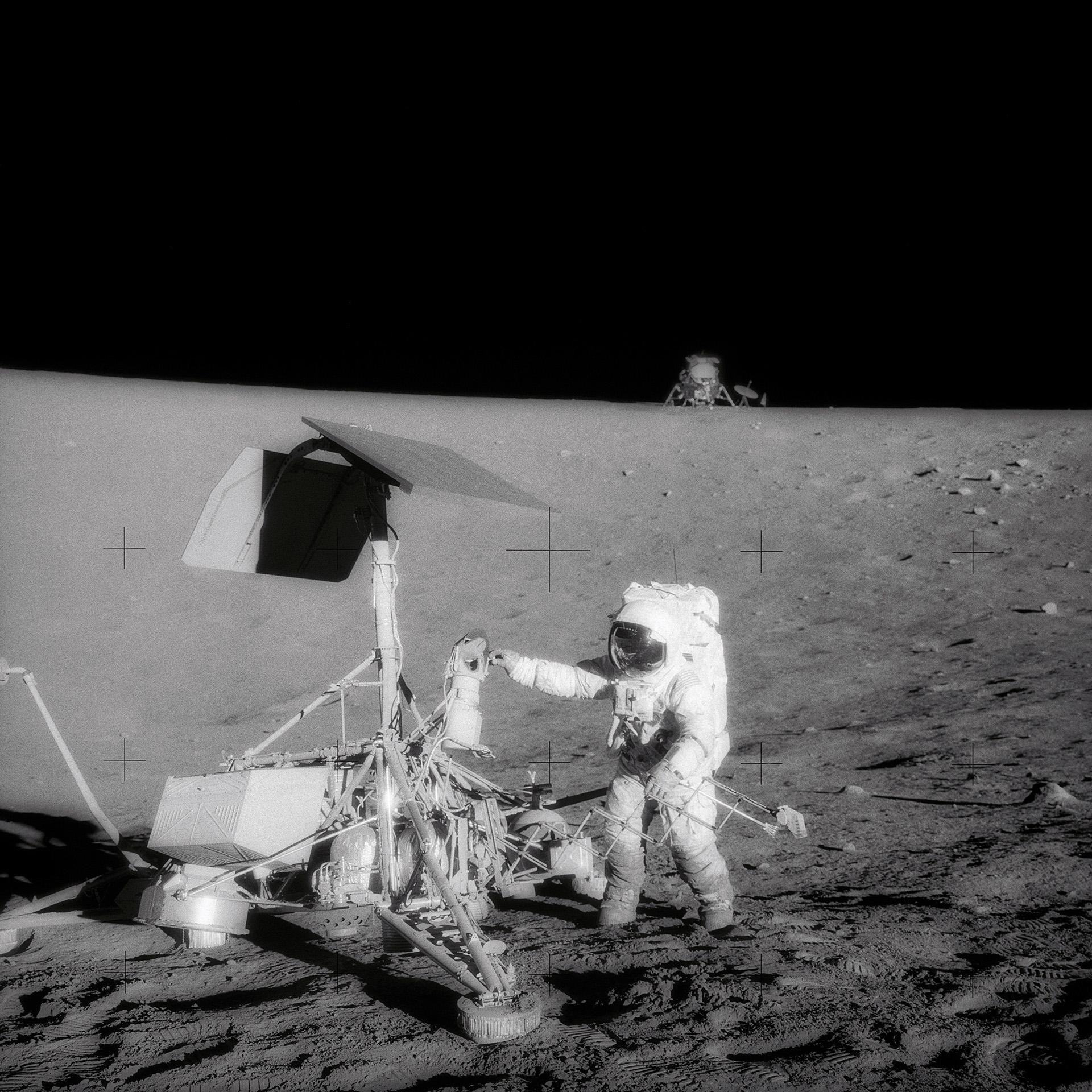 Charles 'Pete' Conrad examines the lunar probe Surveyor 3