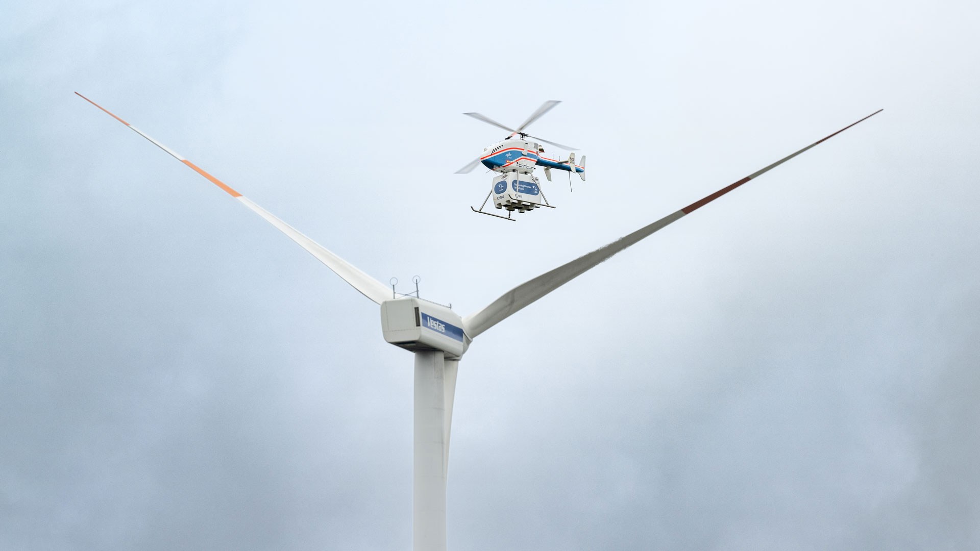 The unmanned DLR helicopter superARTIS near a wind turbine