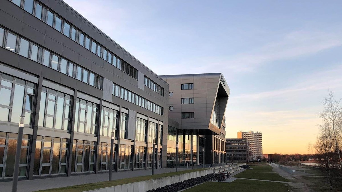 A modern office building of the ZAL TechCenter, situated close to a canal.