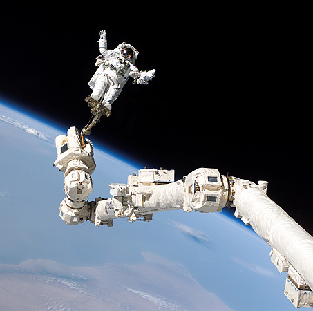 Stephen Robinson aus den USA – an der Spitze des Roboter-Arms der ISS.
Bild: NASA